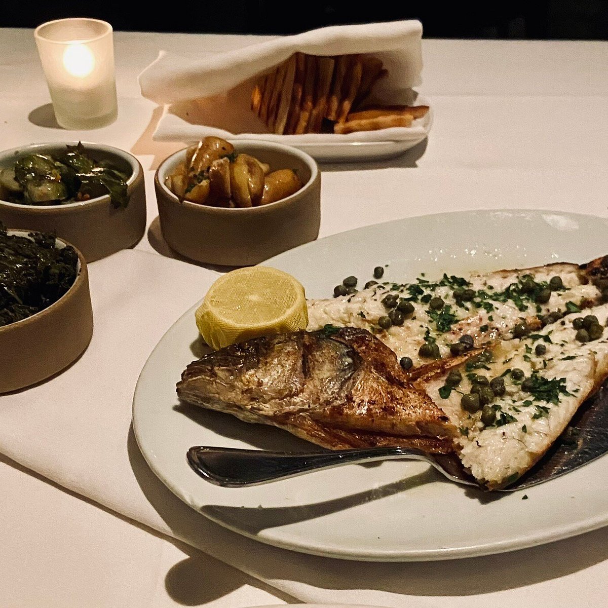 Kyma signature dishes Wood-Grilled Whole Fish (priced by the pound), Octopus, Lamb Chops, Kyma Chips (fried zucchini & eggplant).
